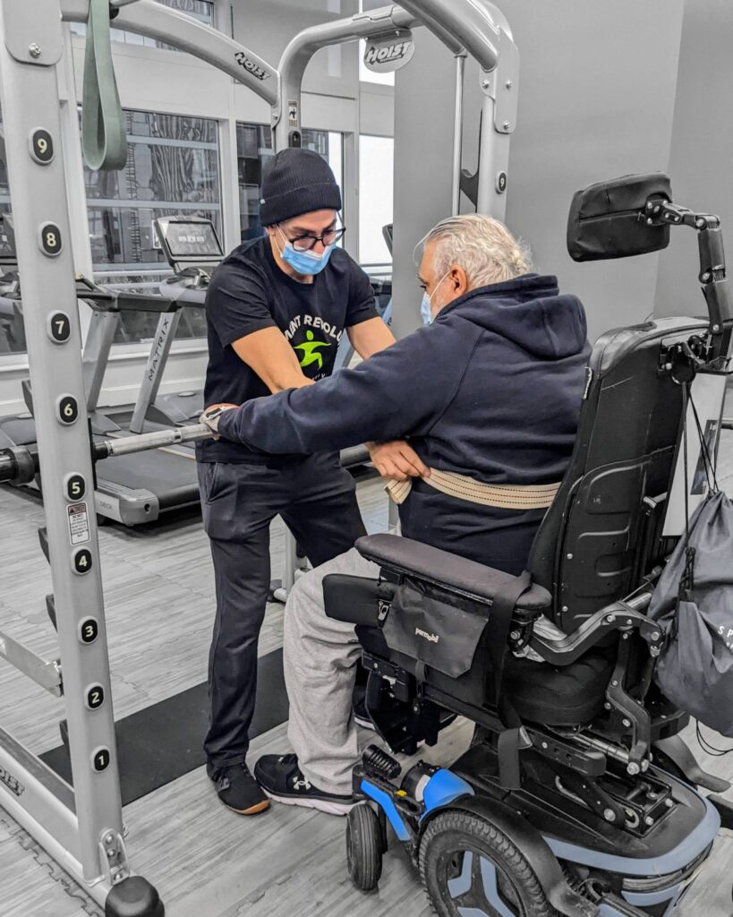 Client in a wheelchair training with a Neuro Exercise Specialist