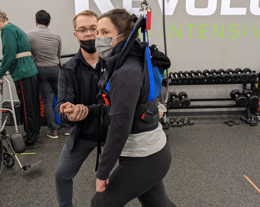Client walking in the body weight support harness